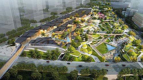 View from above of an architecturally striking mall surrounded by greenery.