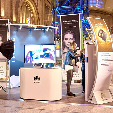A Huawei brand information stand in the middle of a shopping center