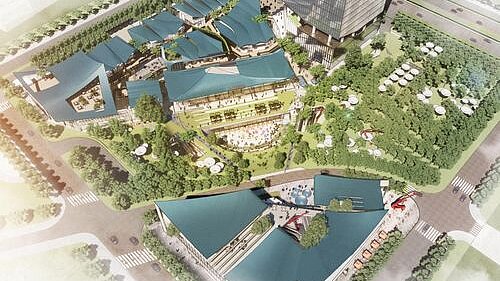 Bird&#039;s eye view of a modern shopping area with striking roofs in the midst of green surroundings.
