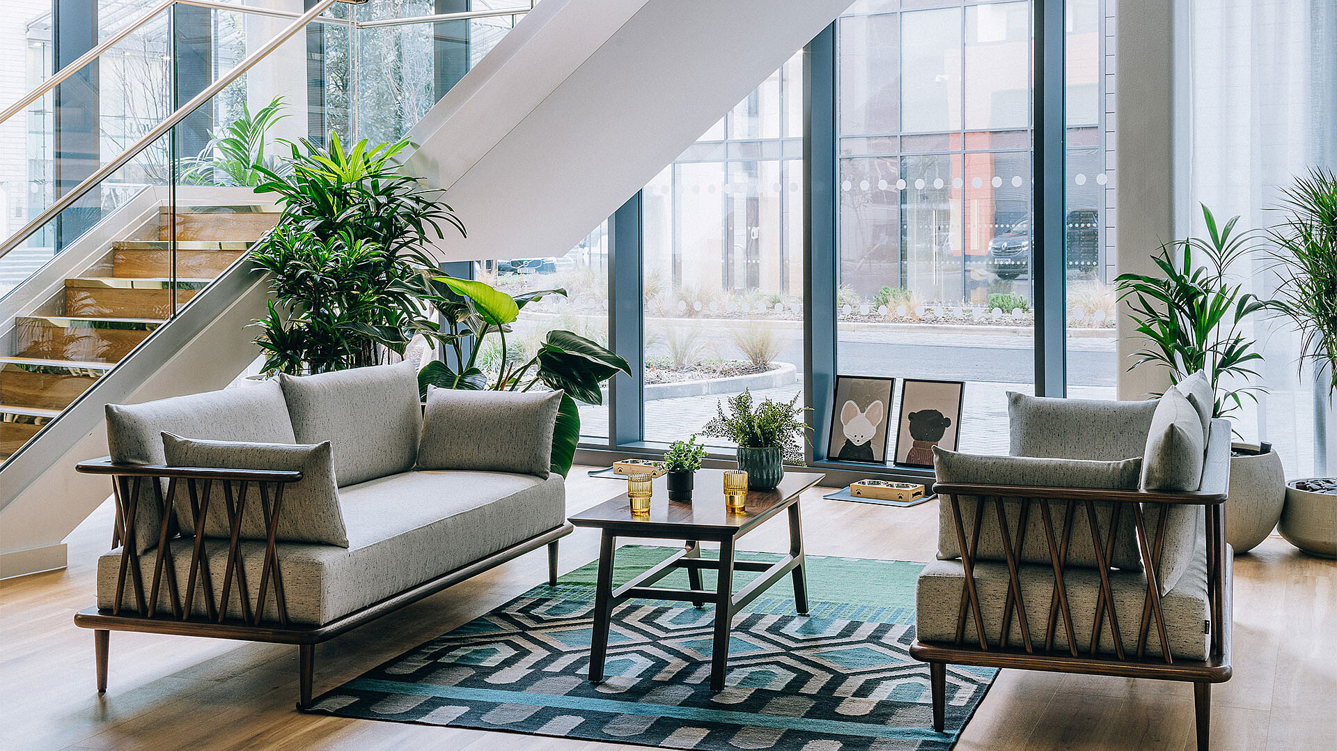 View of a cosy and modern seating area in a living room with large windows.