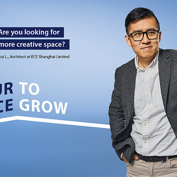 A man against a blue background draws a frame bearing the words "Creating space. Inspiring people. We give you space to inspire people. Find your place with us. Your space to grow.".