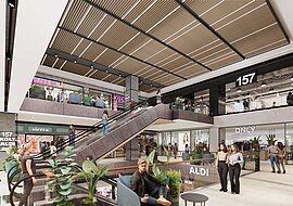 Die Visualisierung zeigt die verschiedenen Stockwerke im Shopping-Center, der Blick geht nach oben und es sind die neuen Läden zu erkennen und eine Rolltreppe. Animierte Menschen vervollständigen das Bild.