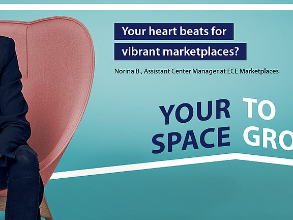 A woman in front of a turquoise background, in the background a frame bearing the words "Creating space. Inspiring people. We give you space to inspire people. Find your place with us. Your space to grow.".