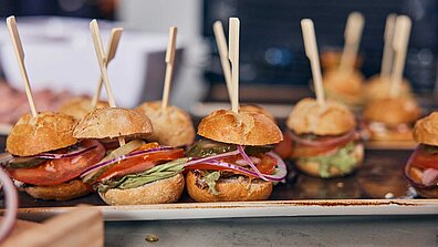 The picture shows mini burgers on a tray.