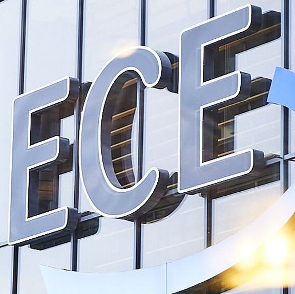 View of the ECE logo on a building façade consisting of glass windows.