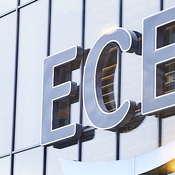 View of the ECE logo on a building façade consisting of glass windows.