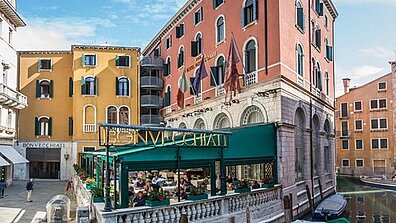 Colorful Mediterranean buildings and the Hotel Bonvecchiati on the Venice Canal