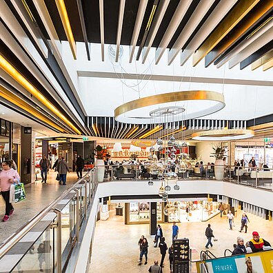 The aisles inside a shopping center with many visitors