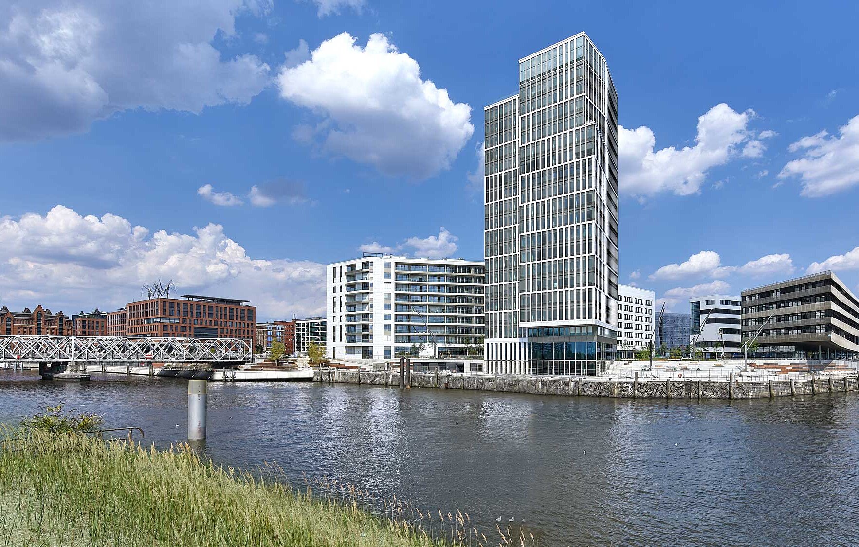 The modern, architecturally special &quot;Freeport&quot; building in Hamburg is surrounded by water.