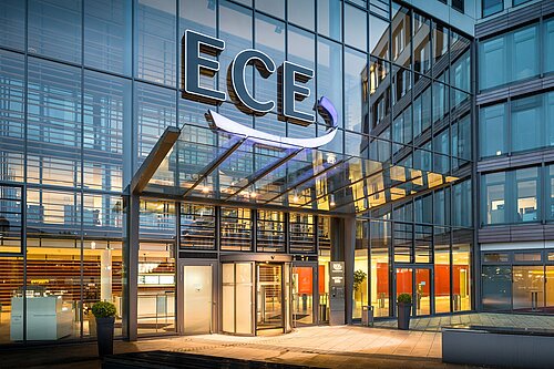 View of the large glass façade of the ECE headquarters in Hamburg.