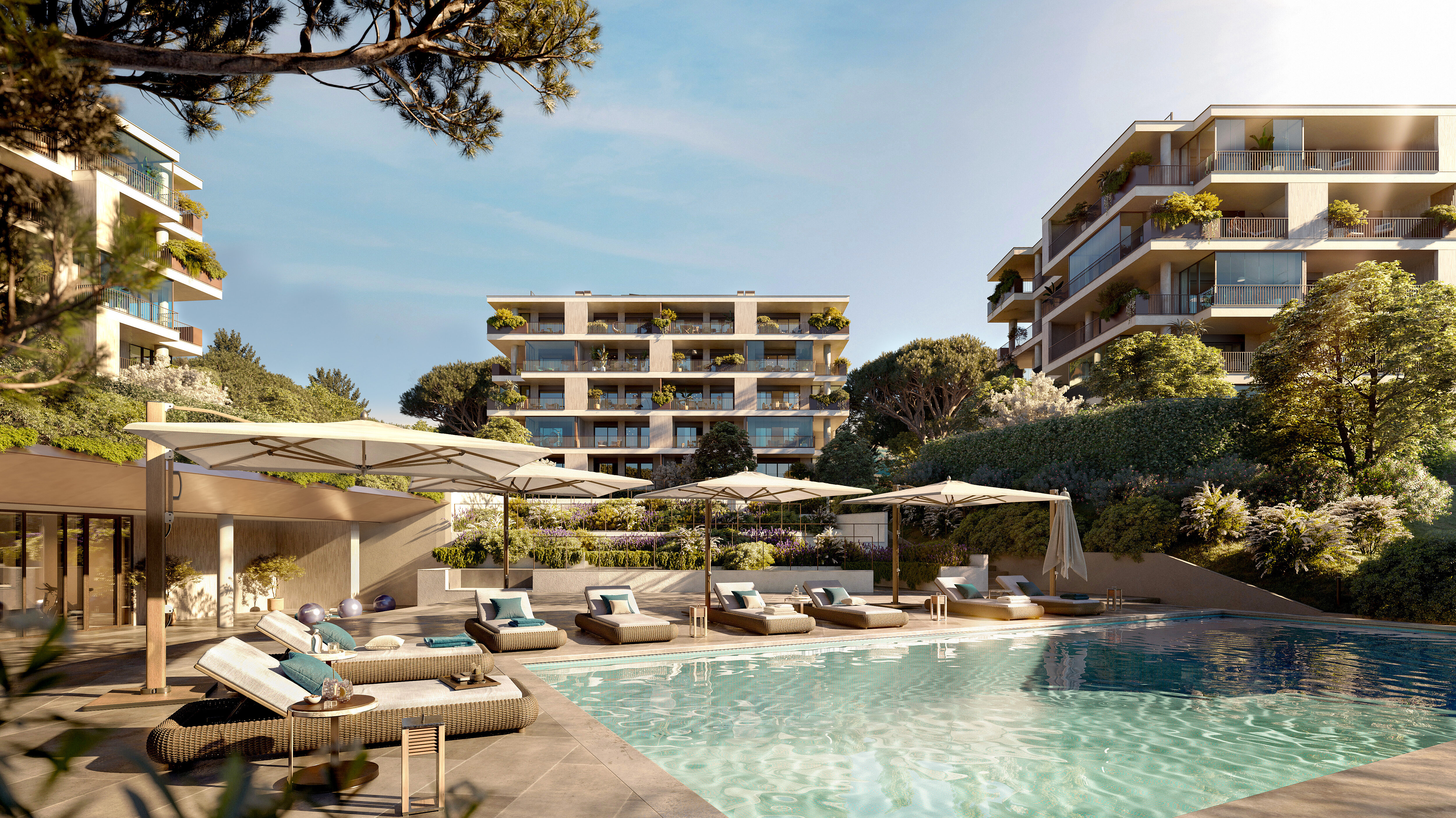 View of a modern outdoor area of a residential neighbourhood surrounded by trees and overlooking a pool and sun loungers.