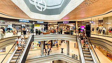 The internal elevation of a busy shopping centre.