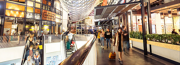 Bright and flashy colors in the middle of a shopping center with many visitors